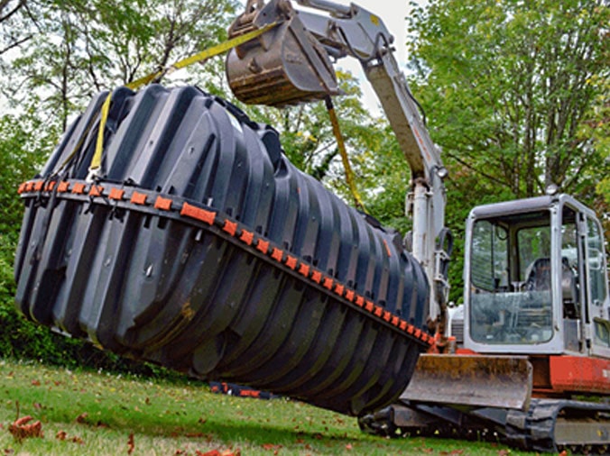 Septic tank beling lowered into the ground